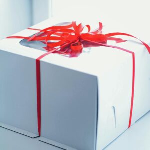 pexels-photo-11112059-11112059 Close-up of a white gift box with a red ribbon, perfect for celebrations and surprises.