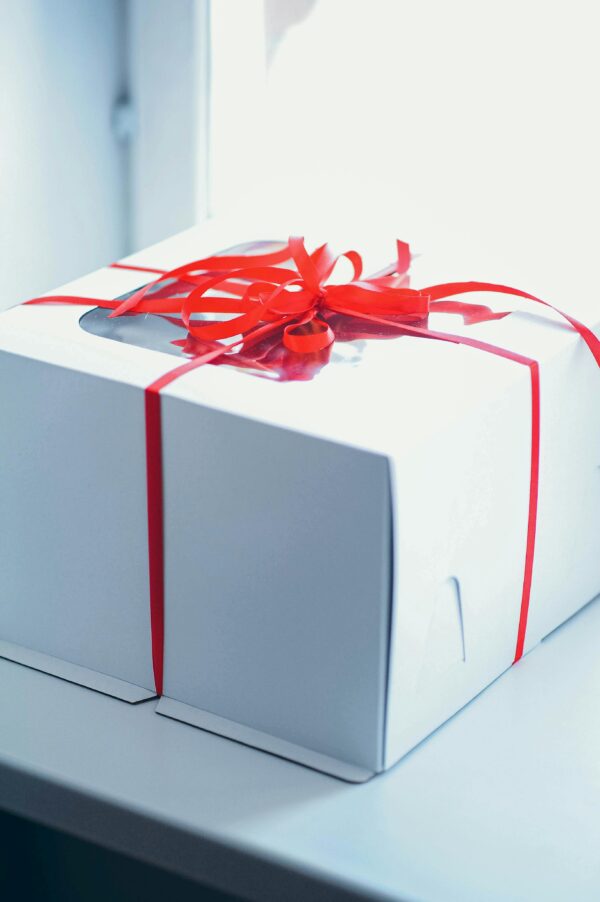 pexels-photo-11112059-11112059 Close-up of a white gift box with a red ribbon, perfect for celebrations and surprises.
