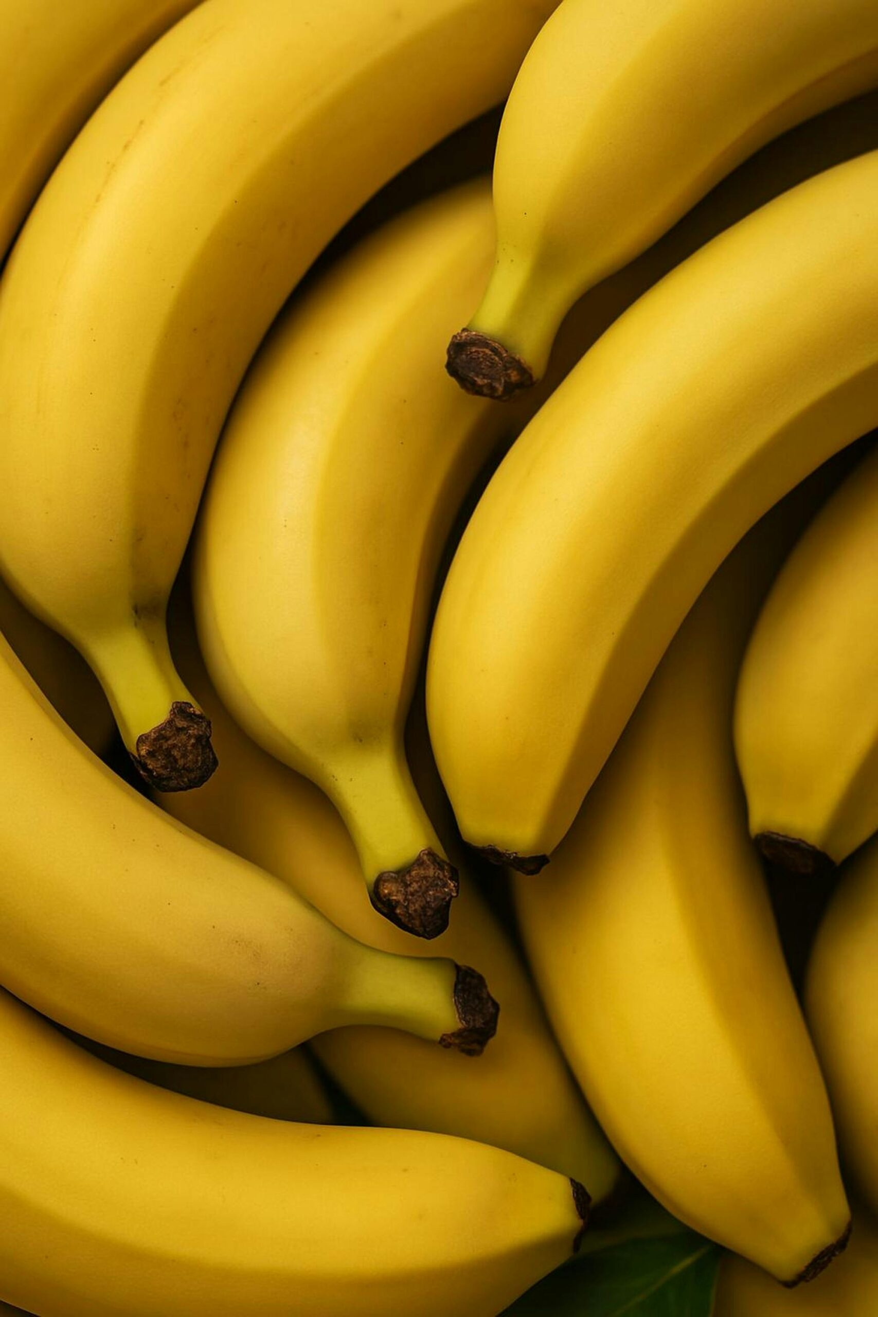 A vibrant collection of ripe bananas with a focus on texture and color, perfect for healthy food concepts.