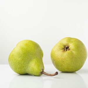 Two ripe pears on a white background, showcasing fresh and healthy produce.